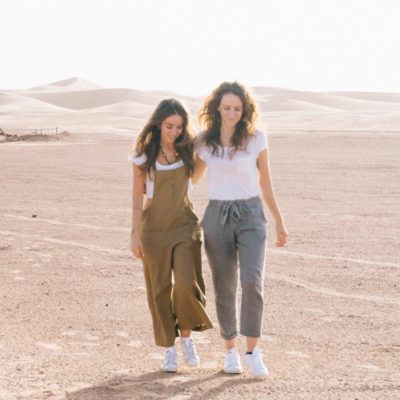 Sisters Alice and Lisa walking in a desert